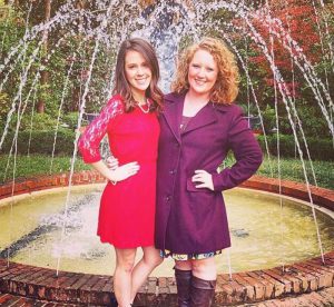 girls in front of a fountain