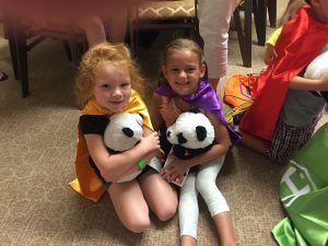 Children with stuffed pandas