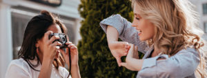 Woman taking photo of her friend
